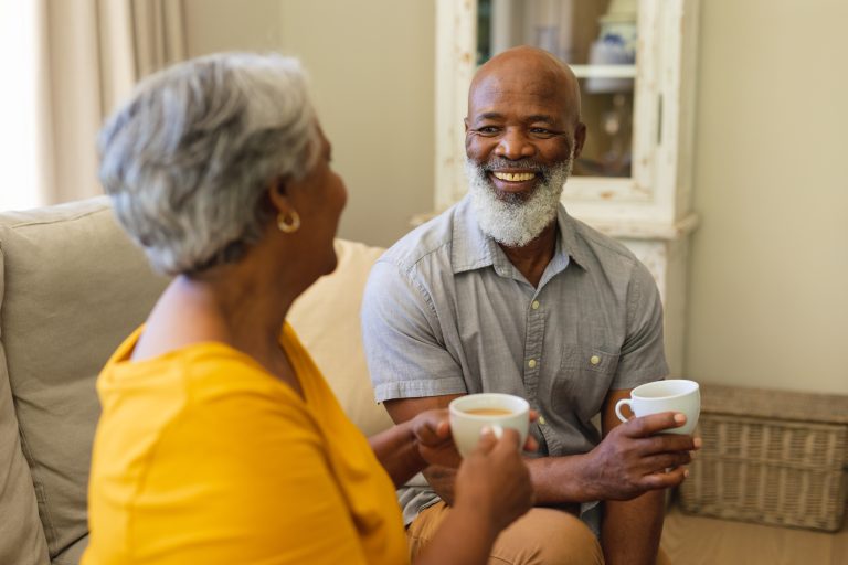 Senior african american couple sitting on sofa